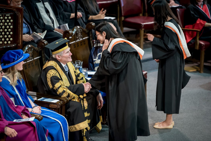 U of T Chancellor Michael Wilson greets graduating students at the June 2018 convocation of Rotman Commerce. Photo by Steve Frost.
