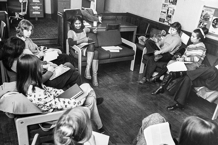Ceta Ramkhalawansingh gestures as she talks to a circle of women sitting in chairs in 1975.