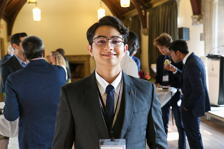 Vidur Narayan Channa smiles while taking part in a social reception in a large hall.