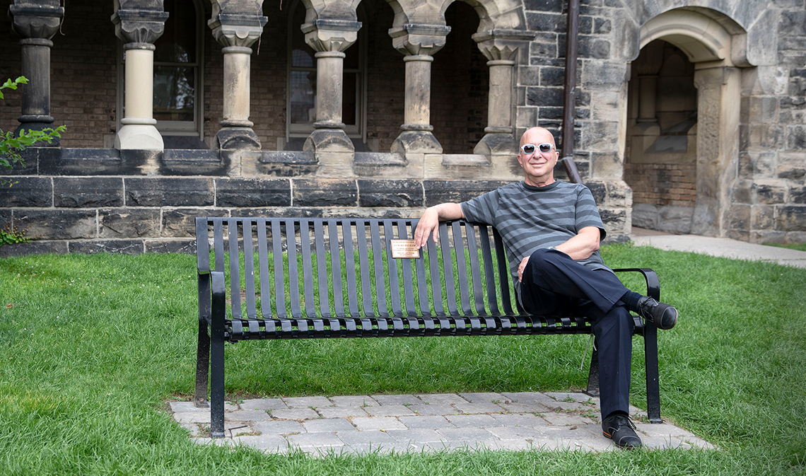 Paul Shaffer sits on a bench outside in King's College Circle.