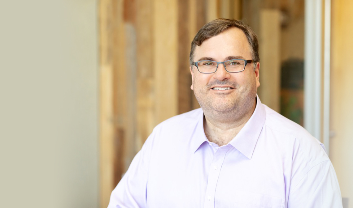 Reid Hoffman smiling, interior of building.