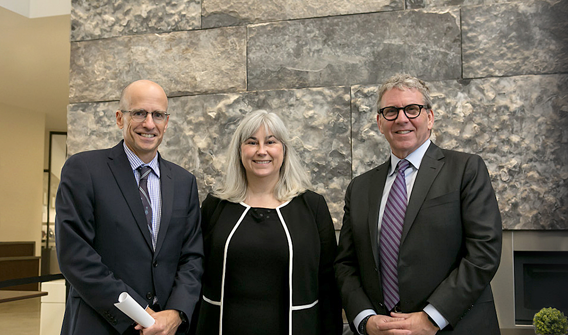 Ed Iacobucci, Cheryl Milne and David Asper smiling in a building interior.