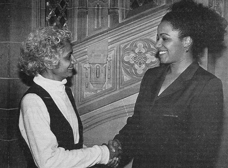 Ceta Ramkhalawansingh and Stefanie Samuels shake hands and smile in this old photograph.
